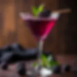 Elegant Black Berry Martini garnished with fresh blackberries.