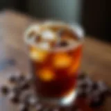 A close-up of a beautifully crafted glass of iced coffee adorned with ice cubes and coffee beans